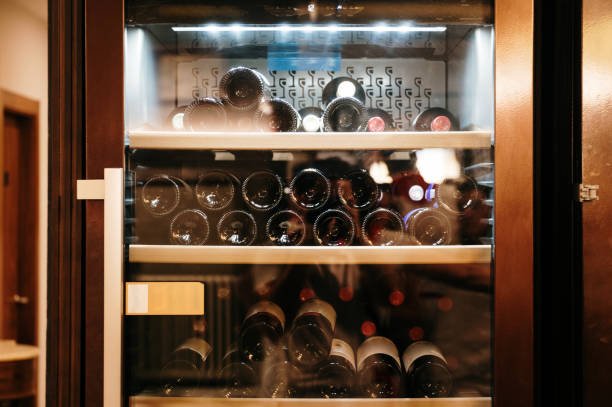 About a wine refrigerator with wine bottles inside